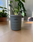 TRĒO Palo Santo candle on a wood table